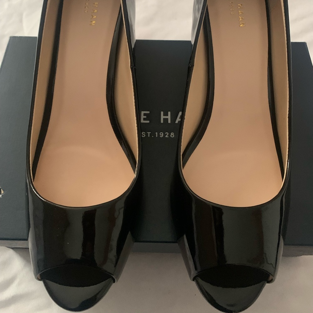 New never worn, black patent, peep toe wedge.